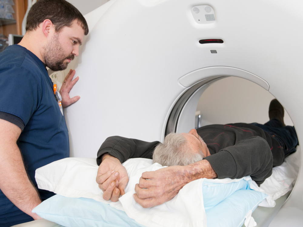 carousel image of patient in CT scanning machine